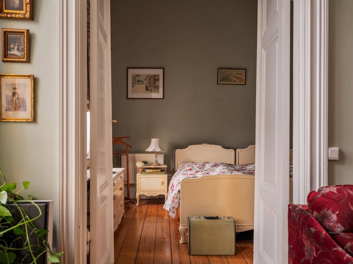 Antique Furniture and Arched Windows in a Stockholm Apartment 14 view into vintage bedroom