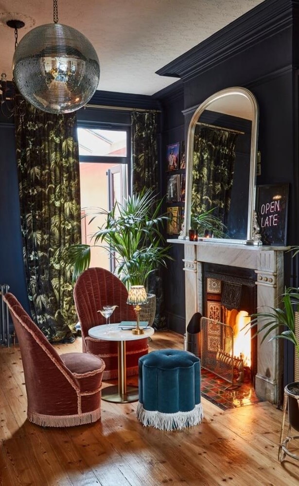 Playful Materials, Textures, and Colors in a London Home 4 vintage style home bar dark blue walls fireplace