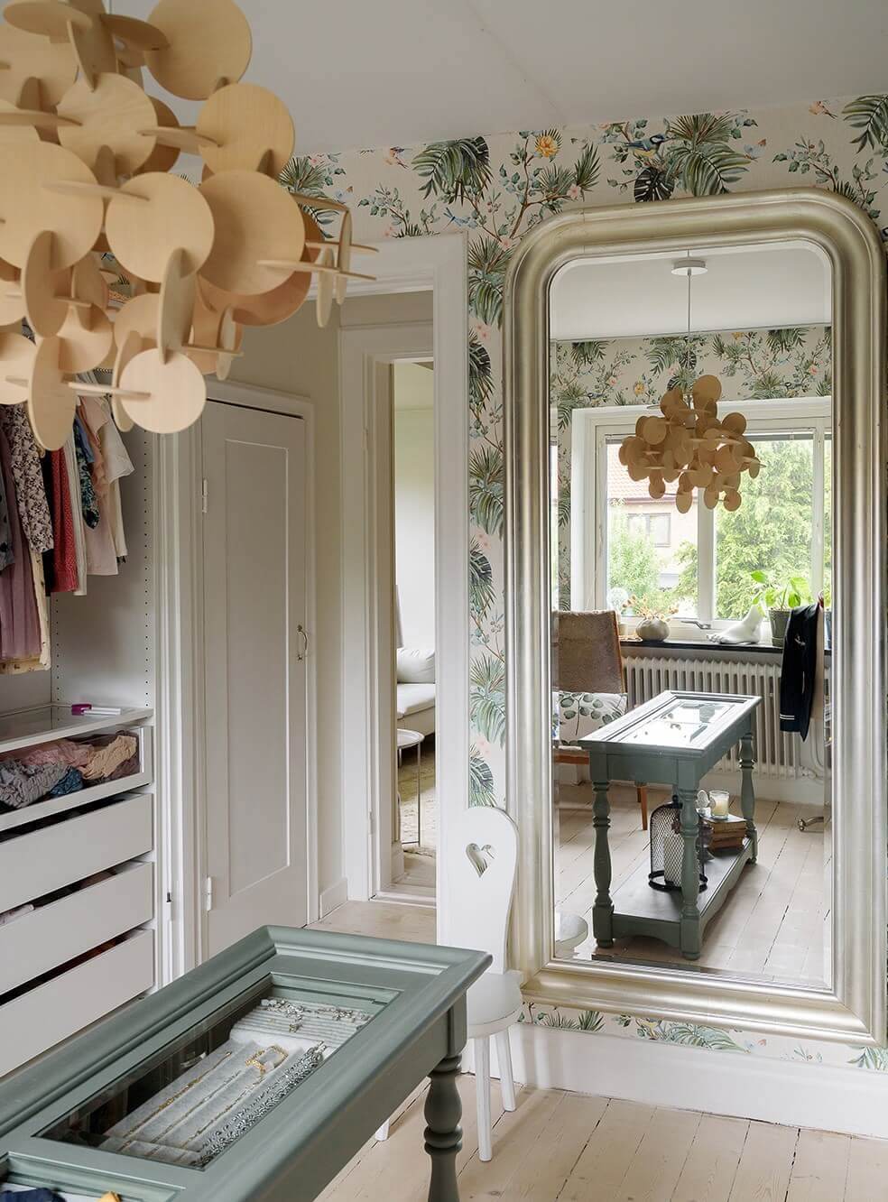 A Beautiful Family Home in a Grand 1930s Villa in Sweden 25 walk in closet with large mirror and wallpaper