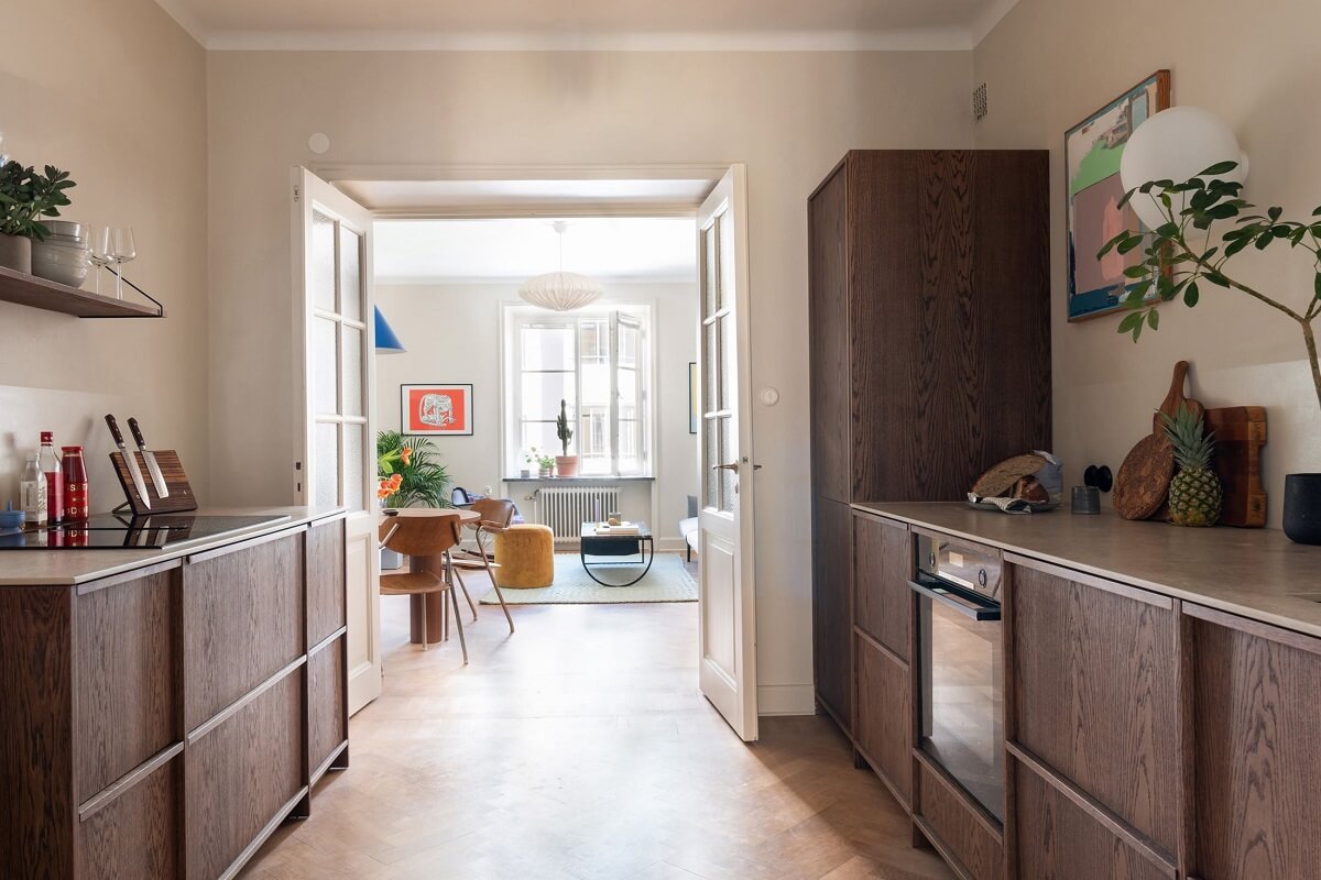 A Renovated Stockholm Apartment with Subtle Color Details 10 walnut kitchen cabinets