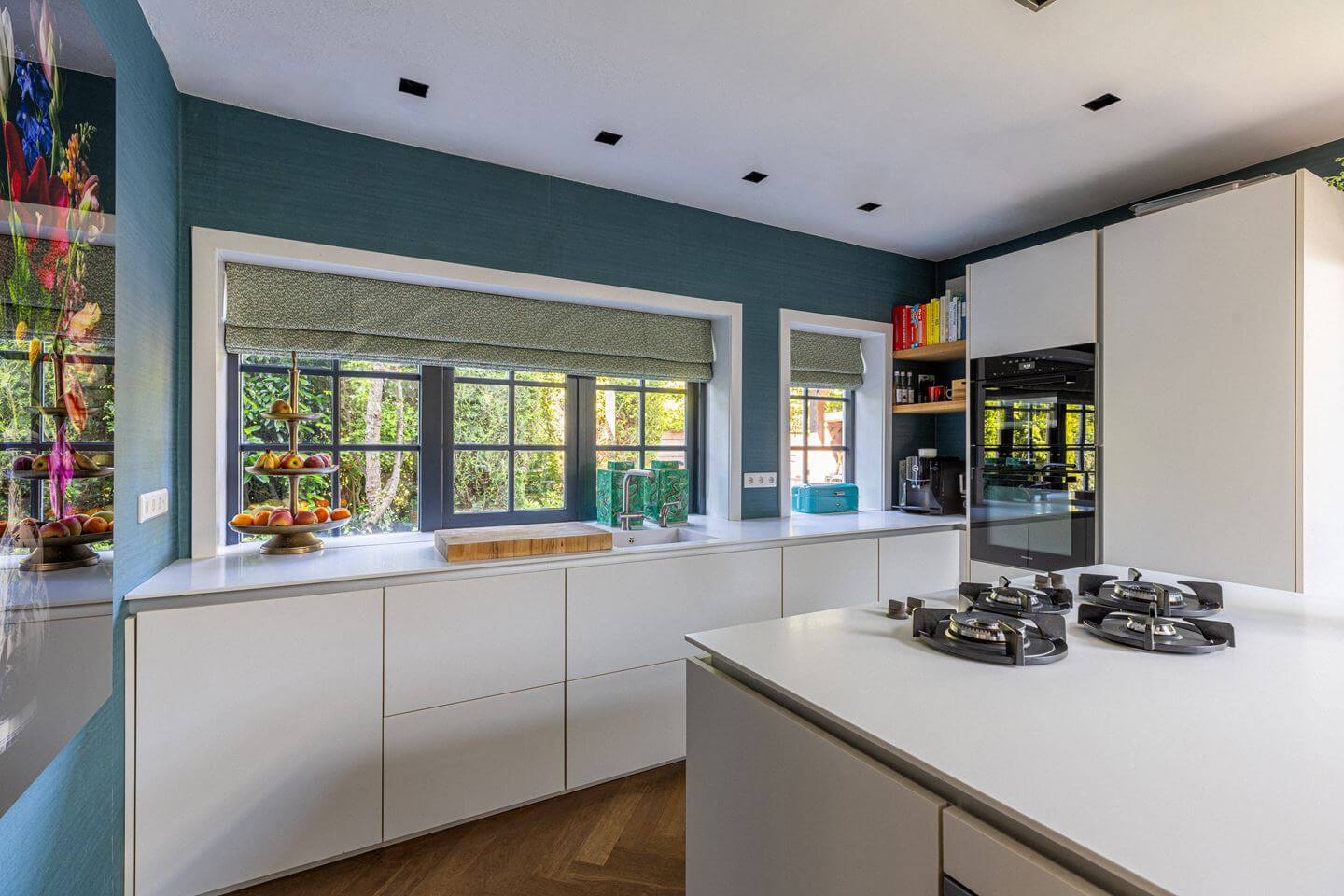 Bold Color Accents in a Dutch Family Home 8 white kitchen cabinets blue wall