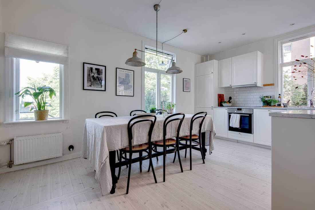 A White Apartment Features a Beautiful Terrace with a View 7 white kitchen with dining table