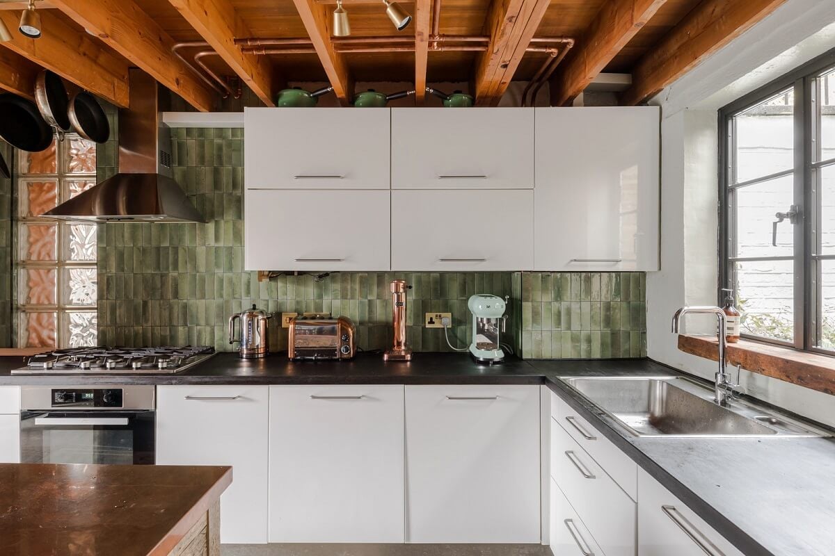 Exposed Materials and Green Tones in a London Stable Conversion 7 white kitchen with green tiles