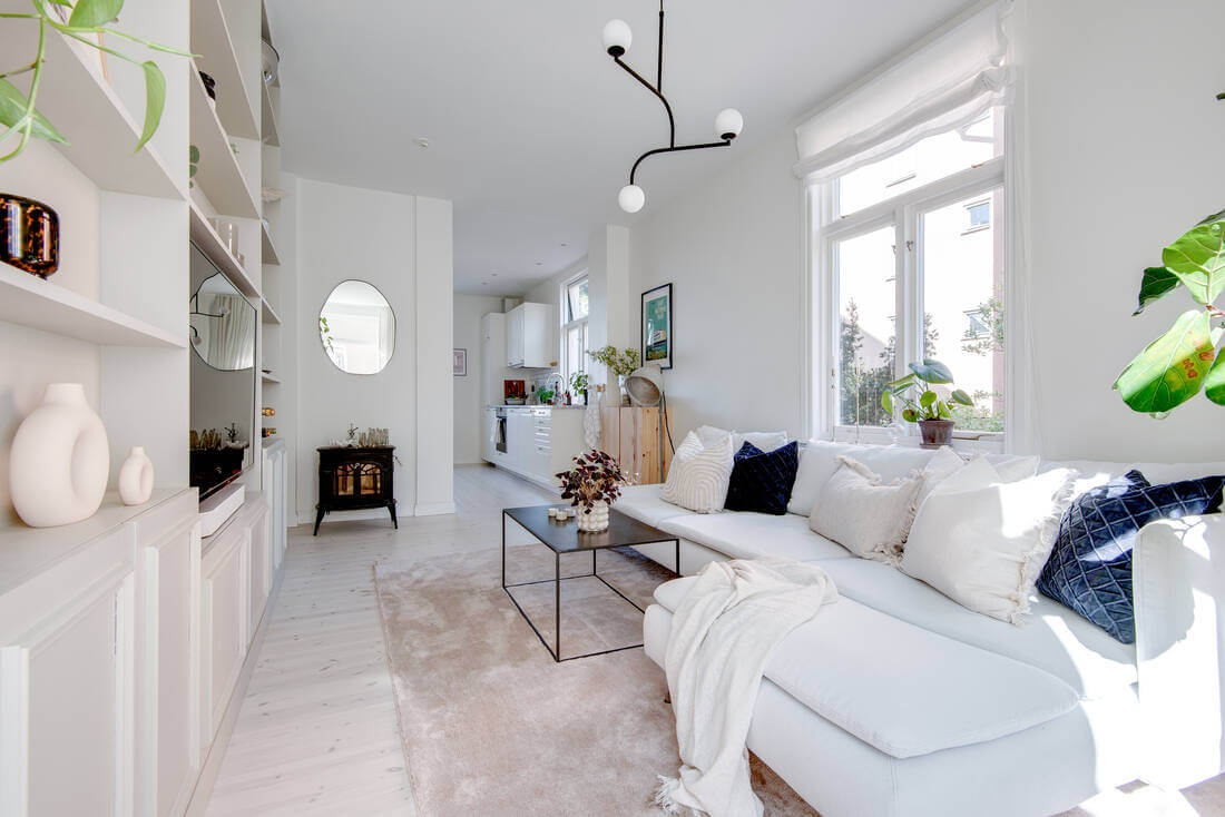 A White Apartment Features a Beautiful Terrace with a View 5 white living room with built in storage