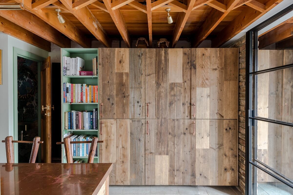 Exposed Materials and Green Tones in a London Stable Conversion 8 wooden cabinets