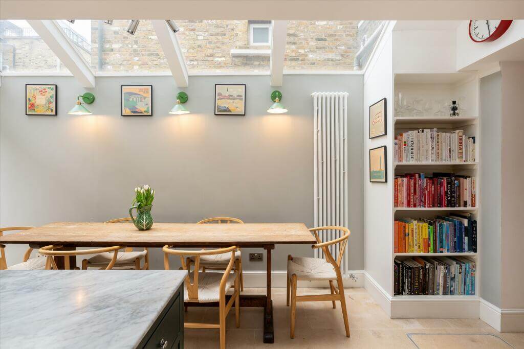 Cottage-style Interiors in a London Family Home 7 wooden dining table under skylights