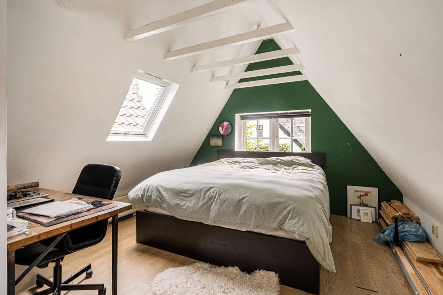 An Old Smokehouse Transformed Into a Modern Industrial Home 24 attic bedroom with green wall