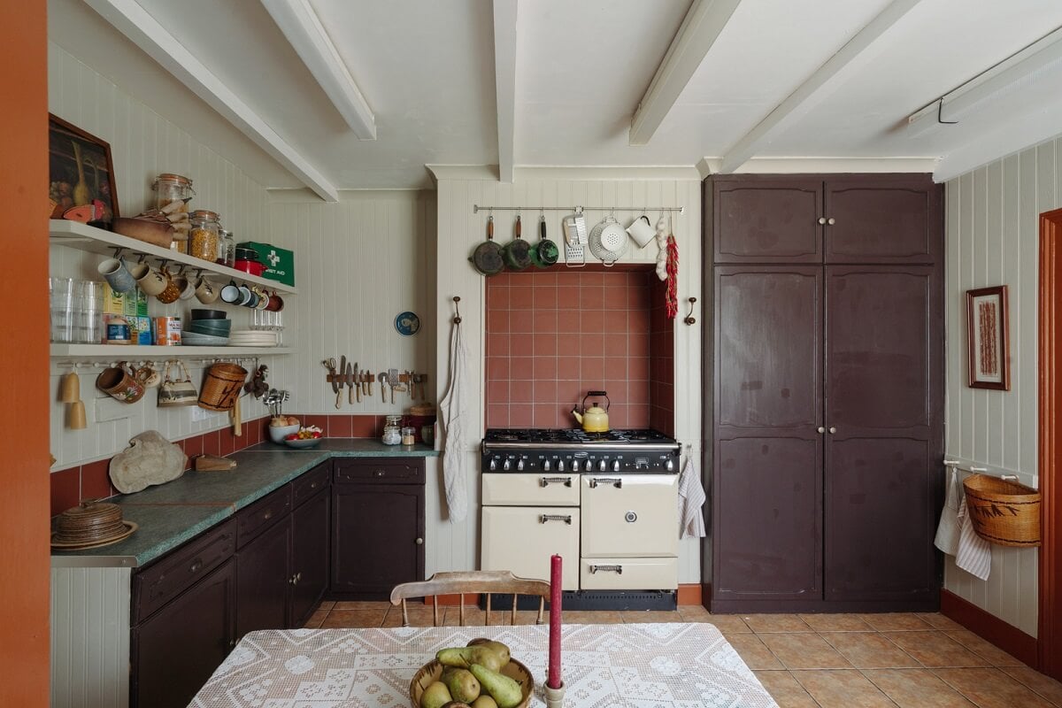 Pared Back Interiors in an English Home in Kent 13 aubergine colored kitchen cabinets red terracotta tiles nordroom