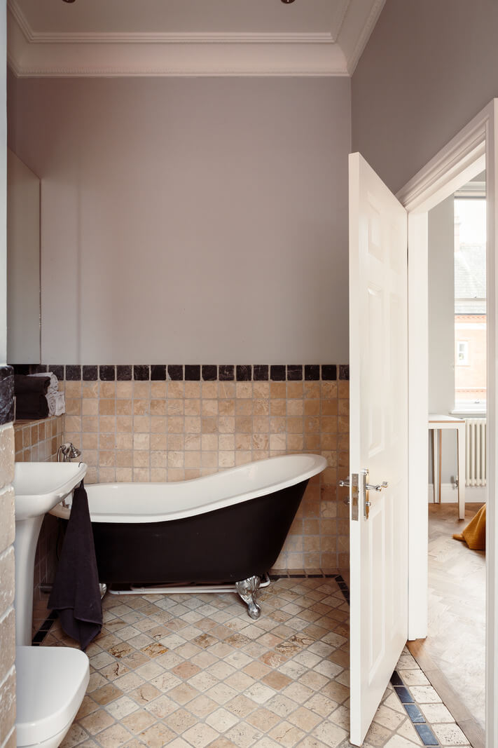 A London Duplex Apartment with a Purple Kitchen 9 bathroom black clawfoot bath gray walls