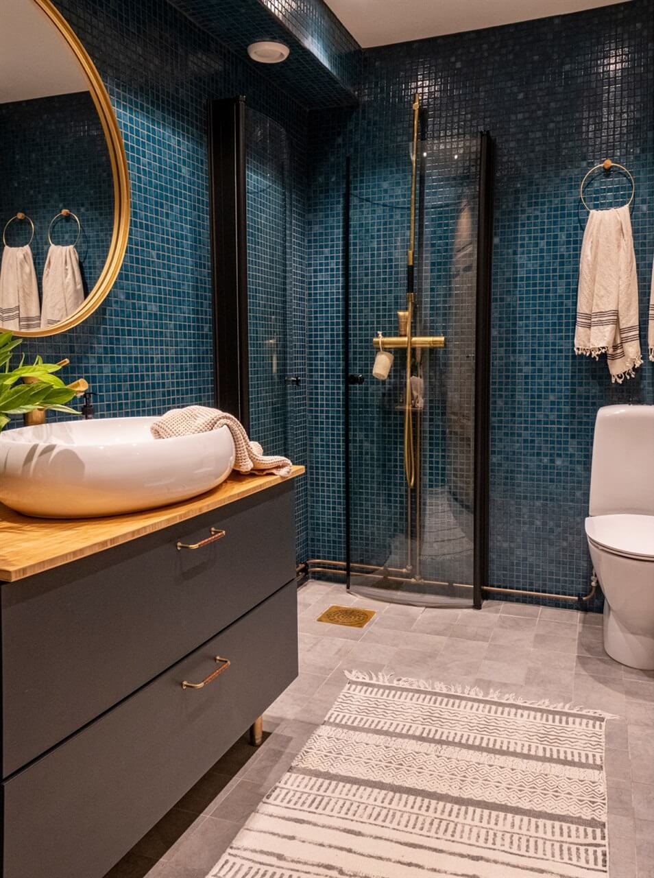 A White Swedish Villa with a Veranda and a Swimming Pool 19 bathroom with blue tiles nordroom