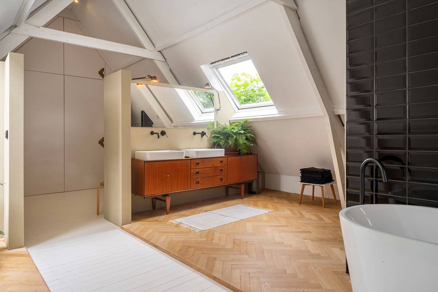 An Old Smokehouse Transformed Into a Modern Industrial Home 21 bathroom with sloped ceiling and bath