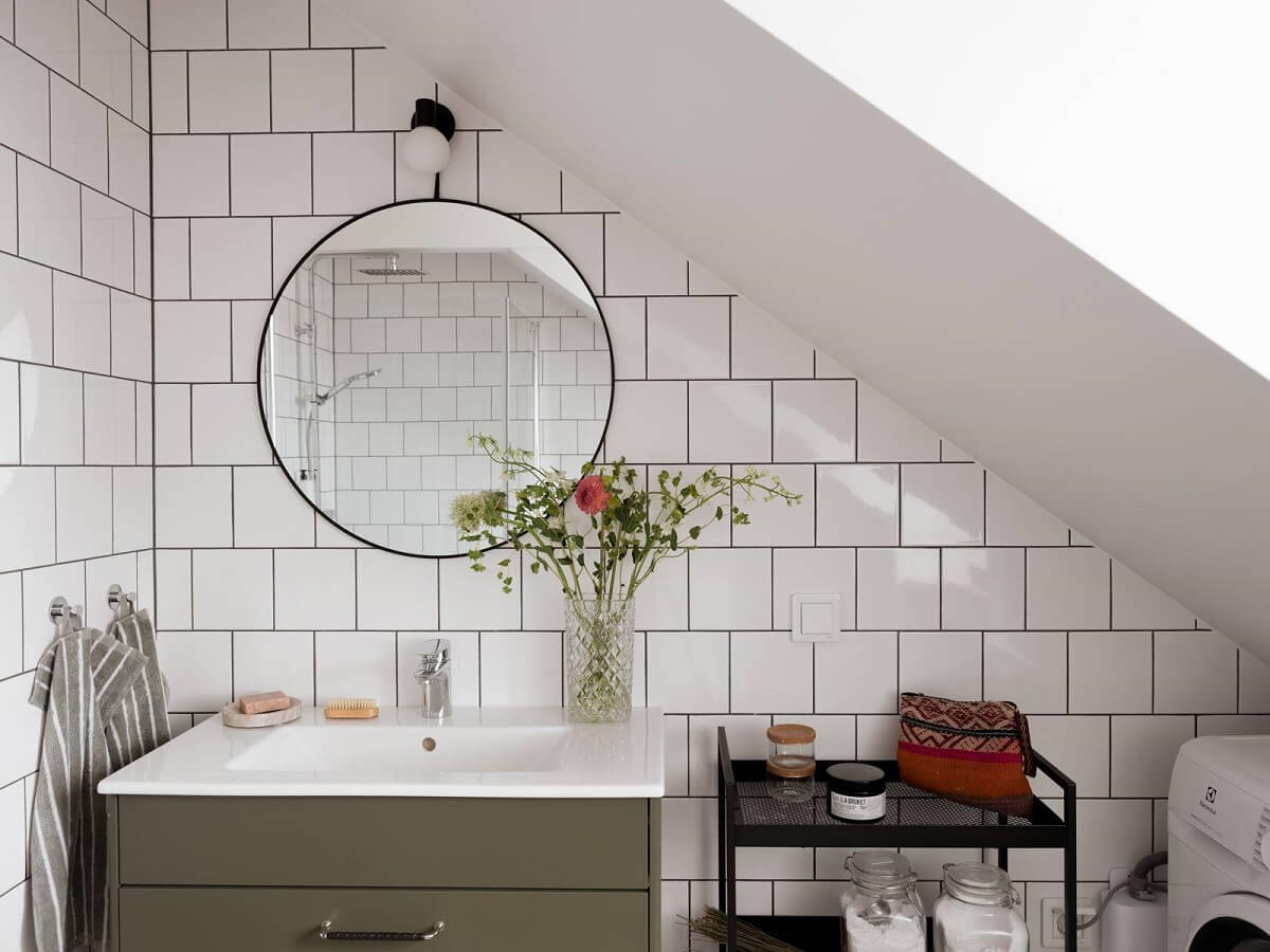 A Beautiful Renovated Maisonette Home with a Calm Color Palette 29 bathroom with white tiles and round mirror
