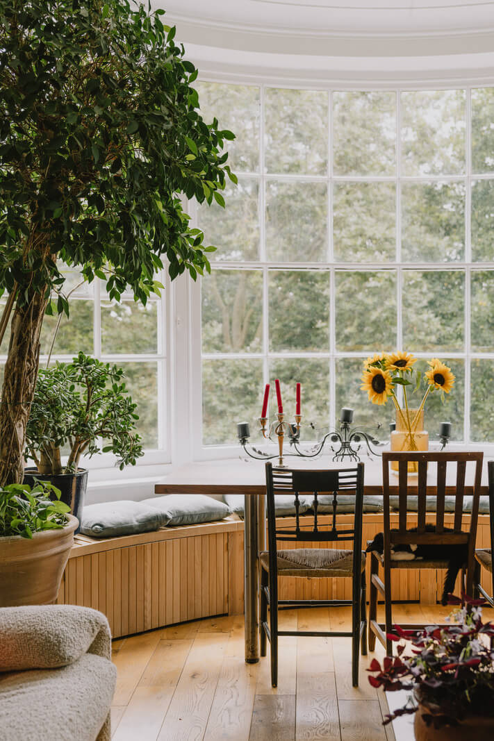 Plants, Art, and a Huge Bay Window in a London Apartment 4 bay window with built in bench and dining table nordroom