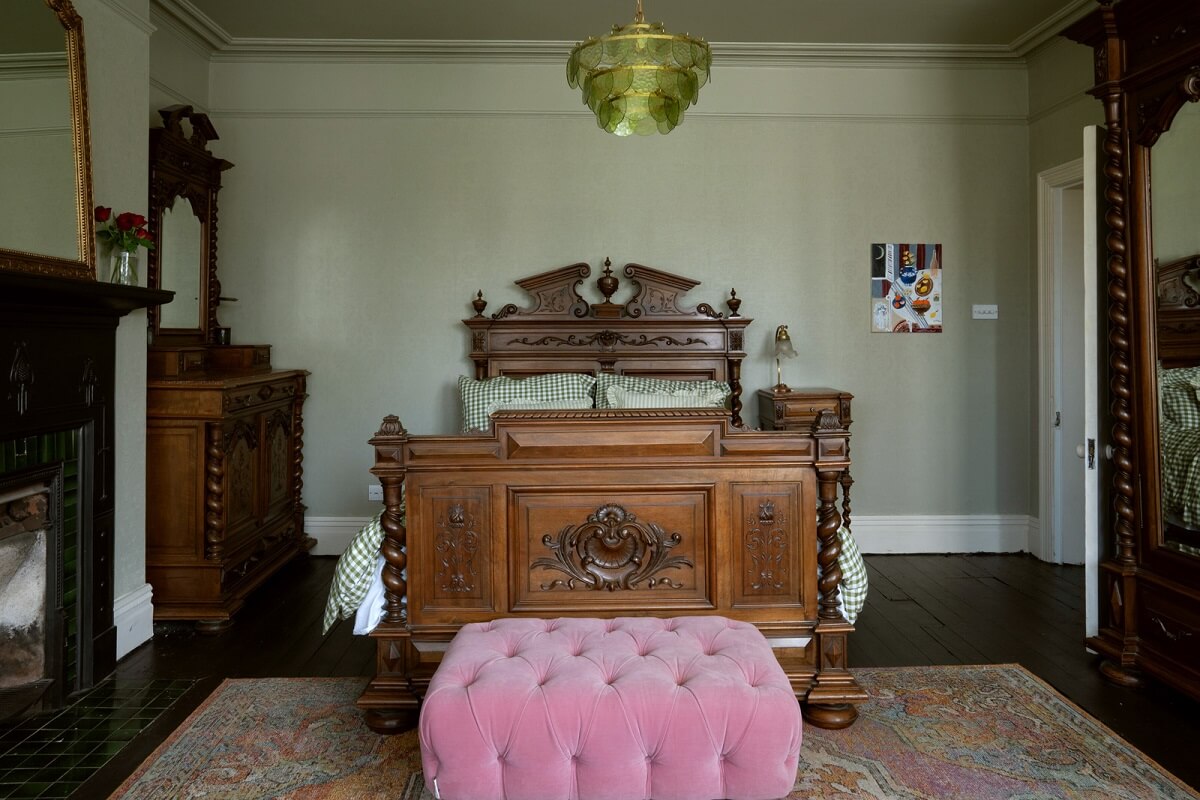 A Beautiful Edwardian House with Period Features 17 bedroom with antique bed and muted green walls