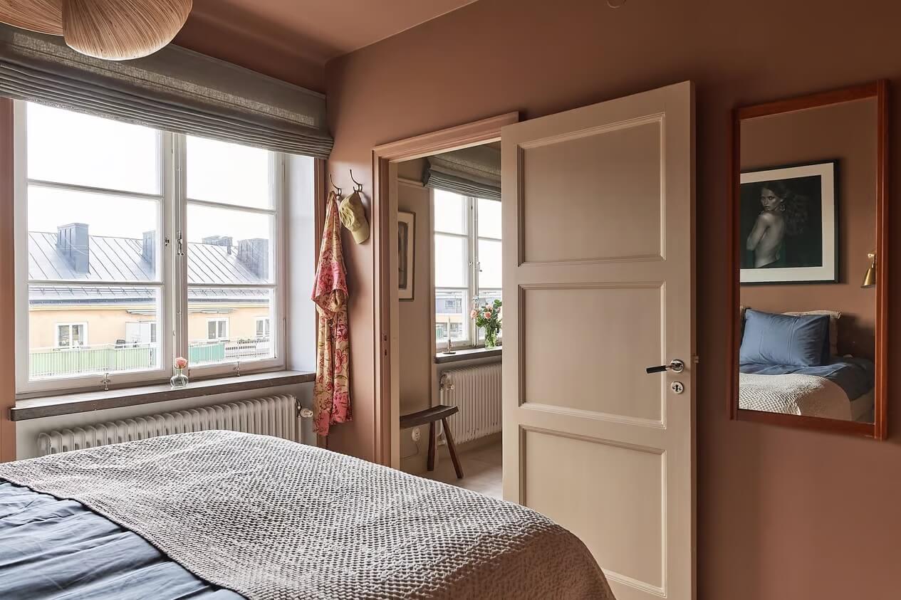 Warm Color-Drenched Rooms in a Swedish Apartment 19 bedroom with color drenched earthy pink paint