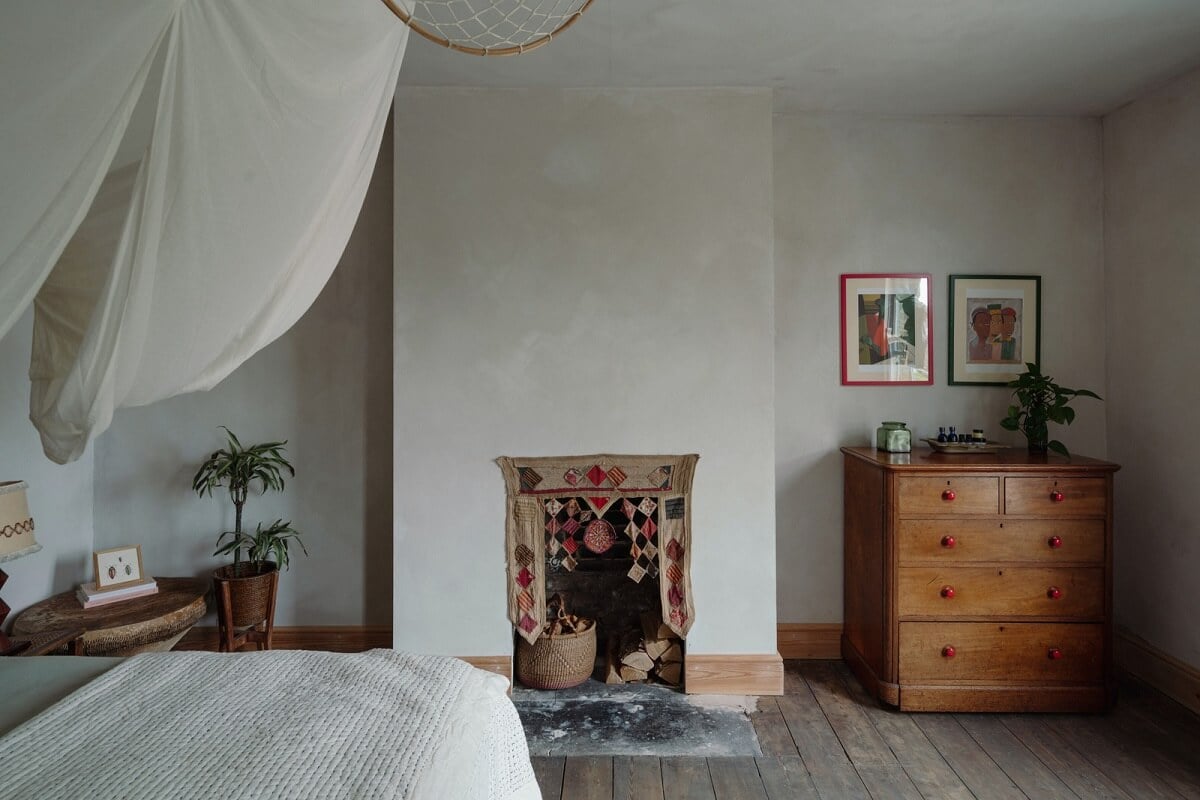 Pared Back Interiors in an English Home in Kent 20 bedroom with fireplace and canopy