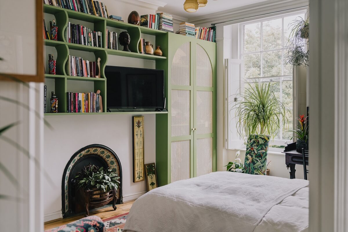Plants, Art, and a Huge Bay Window in a London Apartment 13 bedroom with green built in wardrobes and shelves nordroom