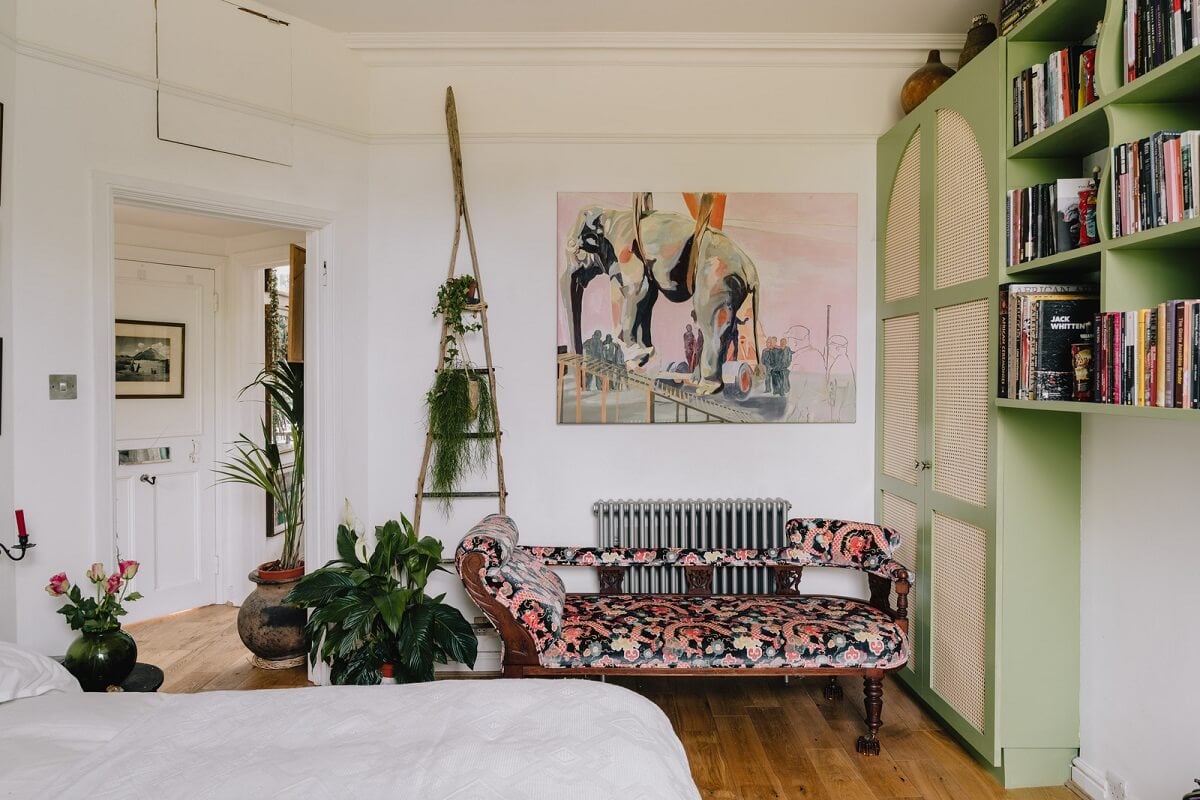 Plants, Art, and a Huge Bay Window in a London Apartment 14 bedroom with green wardrobes and patterned sofa nordroom