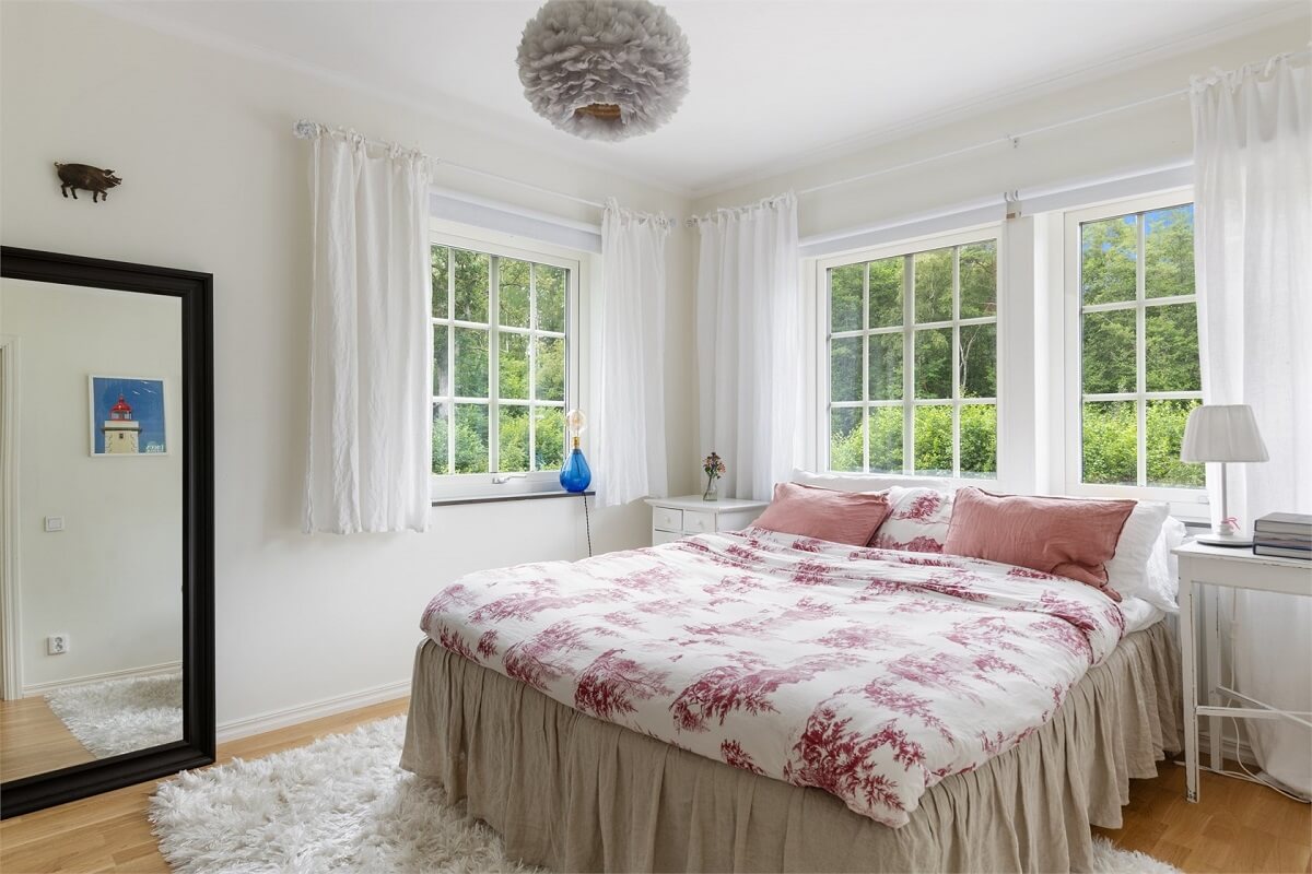 A Bright Open-Plan Swedish Home with a Pink Kitchen 21 bedroom with pink bedding