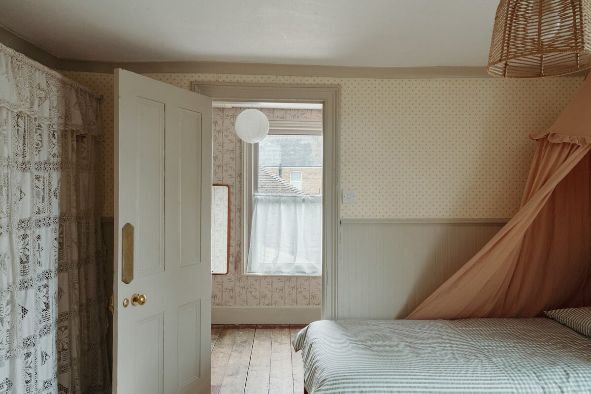 Pared Back Interiors in an English Home in Kent 24 bedroom with pink canopy