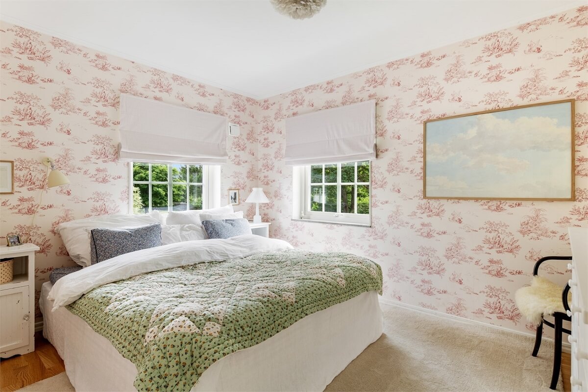 A Bright Open-Plan Swedish Home with a Pink Kitchen 22 bedroom with pink wallpaper