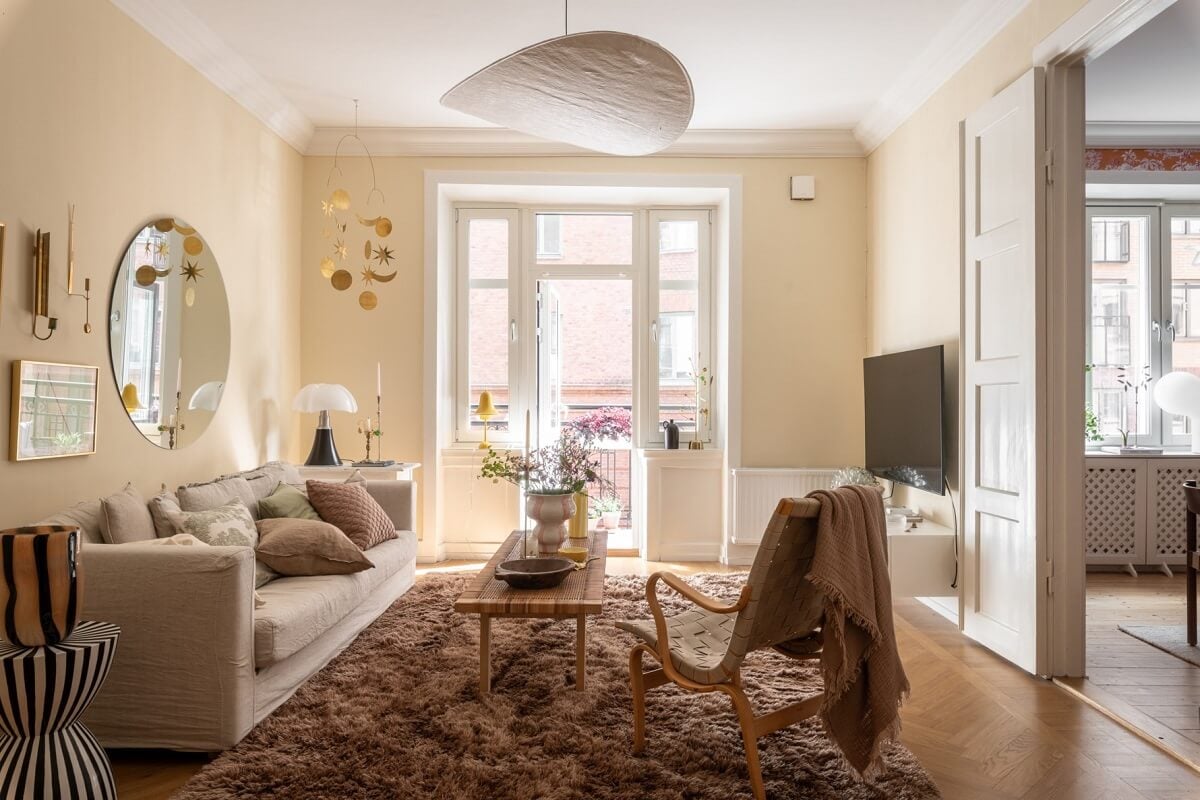 A Scandinavian Apartment with a Pale Yellow Living Room 2 beige living room with large cozy rug
