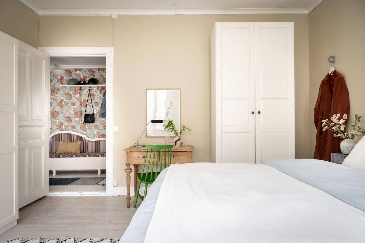 A Bright Swedish Apartment with Subtle Color Accents 19 beige scandi bedroom with wooden desk nordroom