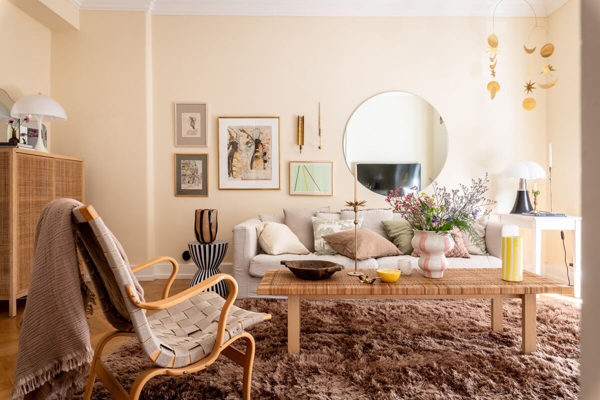 A Scandinavian Apartment with a Pale Yellow Living Room 1 beige walls round mirror living room
