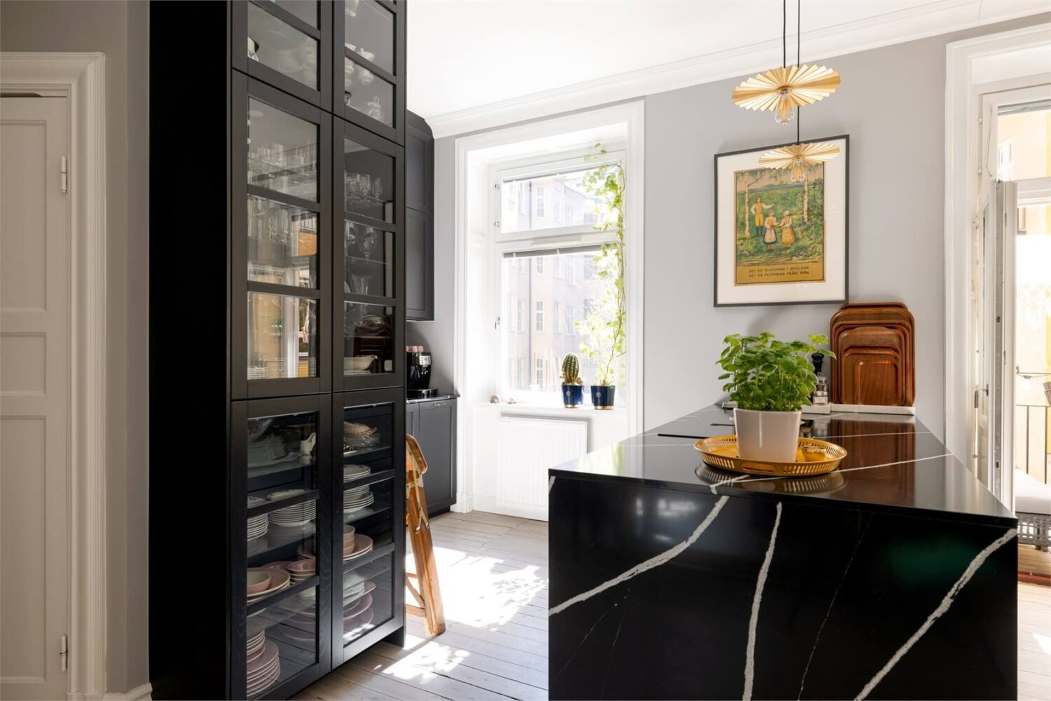 A Lovely Stockholm Apartment with a Black Kitchen and Pink Bedroom 4 black kitchen with glass front cabinets