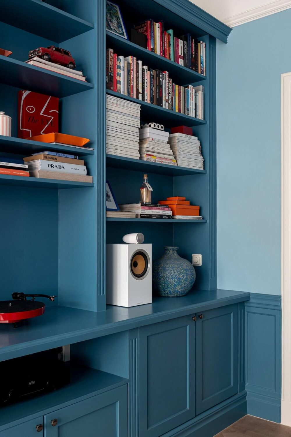 A Classic Apartment with a Blue Living Room 7 blue built in bookcases nordroom
