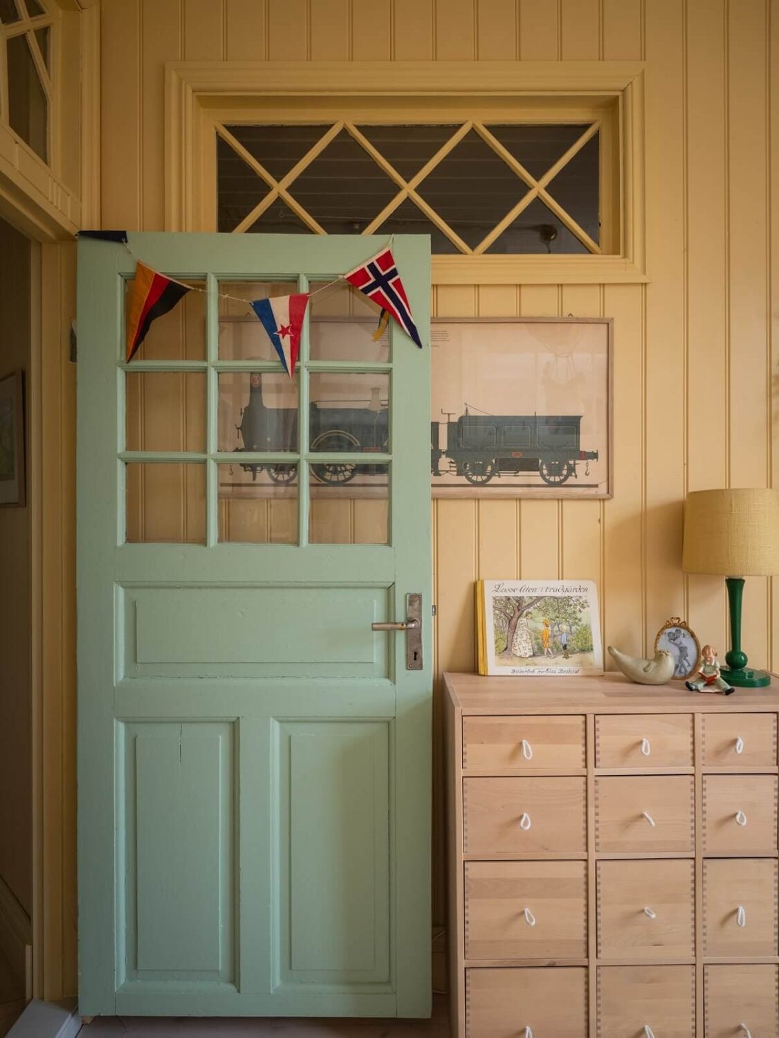 Charming Vintage Country Style in a Family Apartment in Sweden 23 blue door and yellow wooden wall