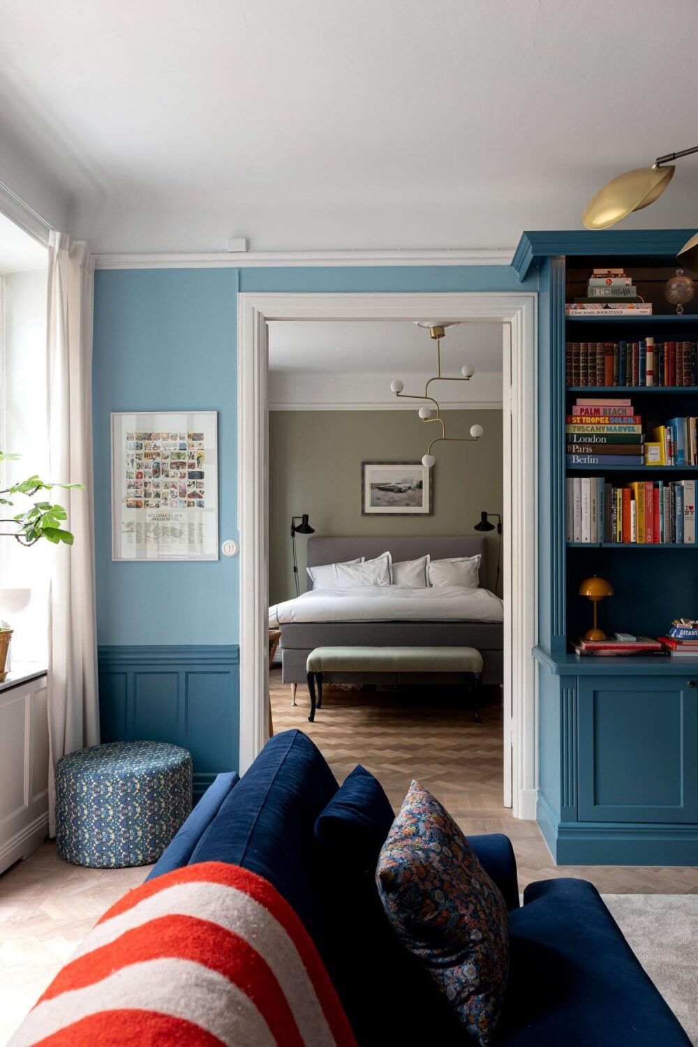 A Classic Apartment with a Blue Living Room 10 blue living room with view into bedroom