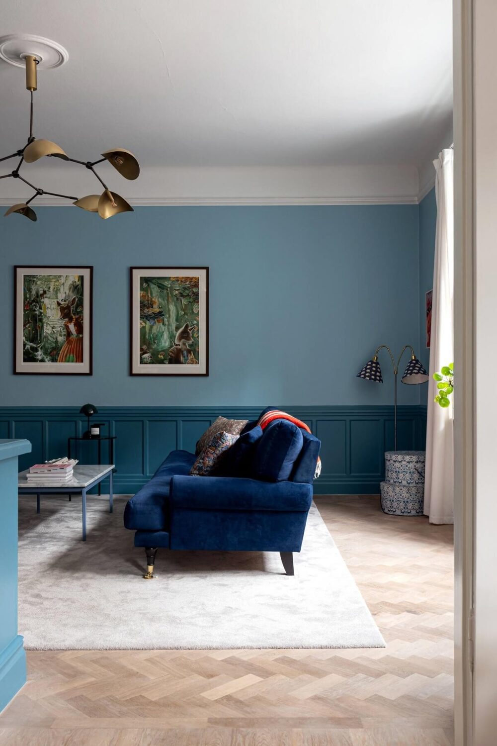 A Classic Apartment with a Blue Living Room 6 blue sitting room with parquet floor nordroom