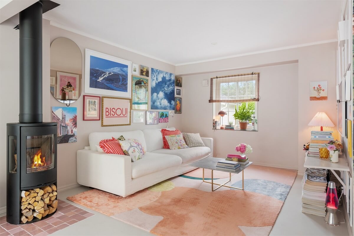 A Bright Open-Plan Swedish Home with a Pink Kitchen 2 bright living room with pastel rug and art