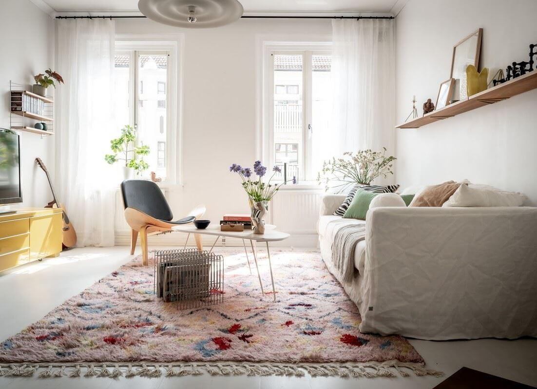 A Bright Swedish Apartment with Subtle Color Accents 2 bright scandi living room with large pastel rug nordroom