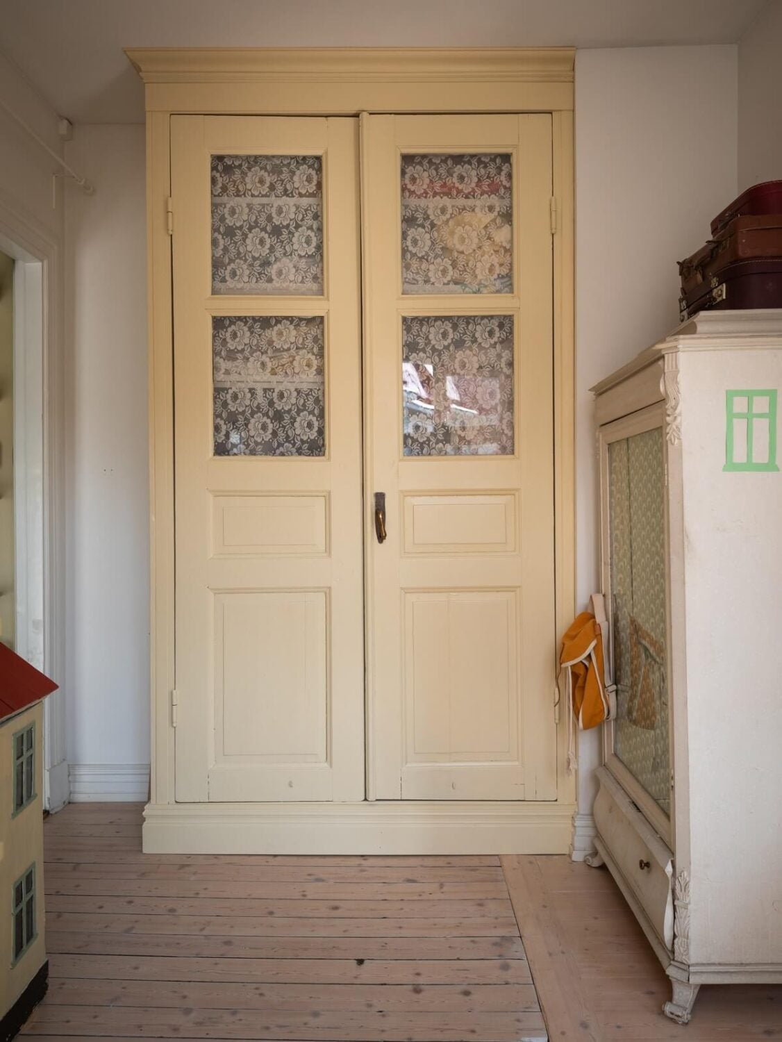 Charming Vintage Country Style in a Family Apartment in Sweden 29 butter yellow cabinet