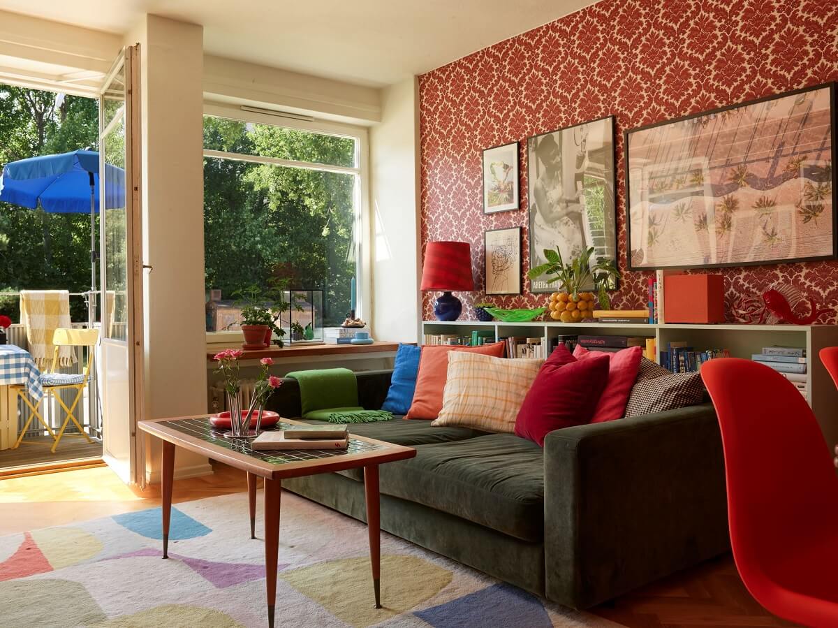 A Colorful Swedish Apartment Inspired by the 50s and 70s 8 cheerful living room with green sofa and colorful textiles