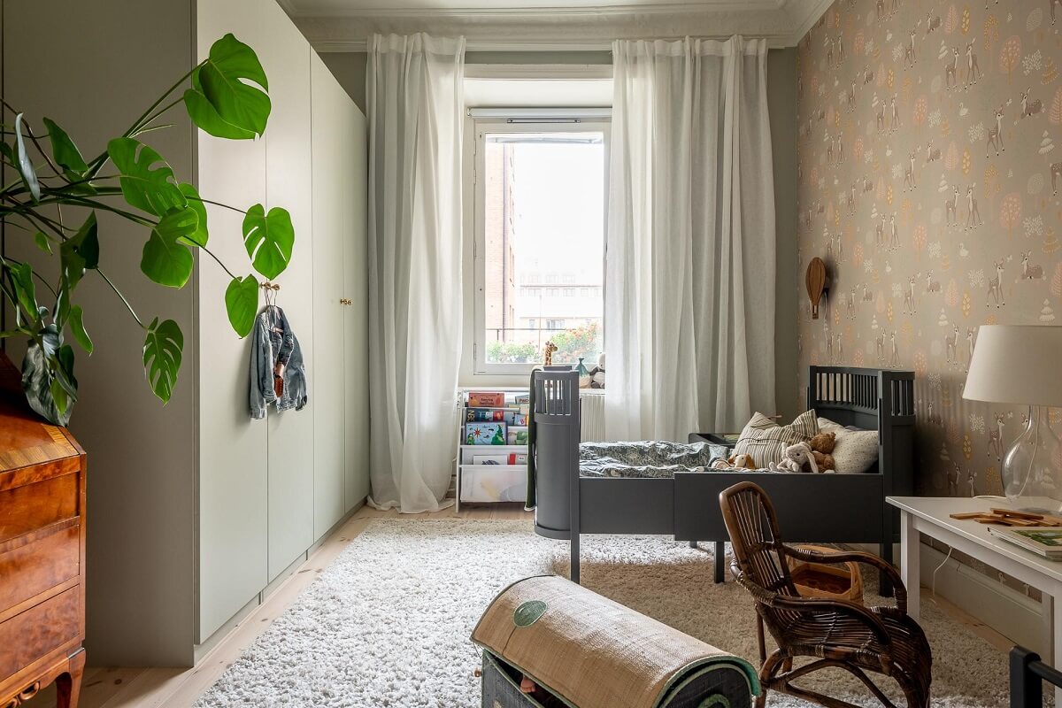 A Spacious Renovated Apartment with a Light Pink Living Room 23 childrens bedroom with wallpaper nordroom