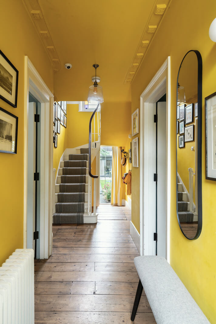 A Beautiful London Family Home with Colorful Accents 15 color drenched yellow hallway with wooden floor nordroom