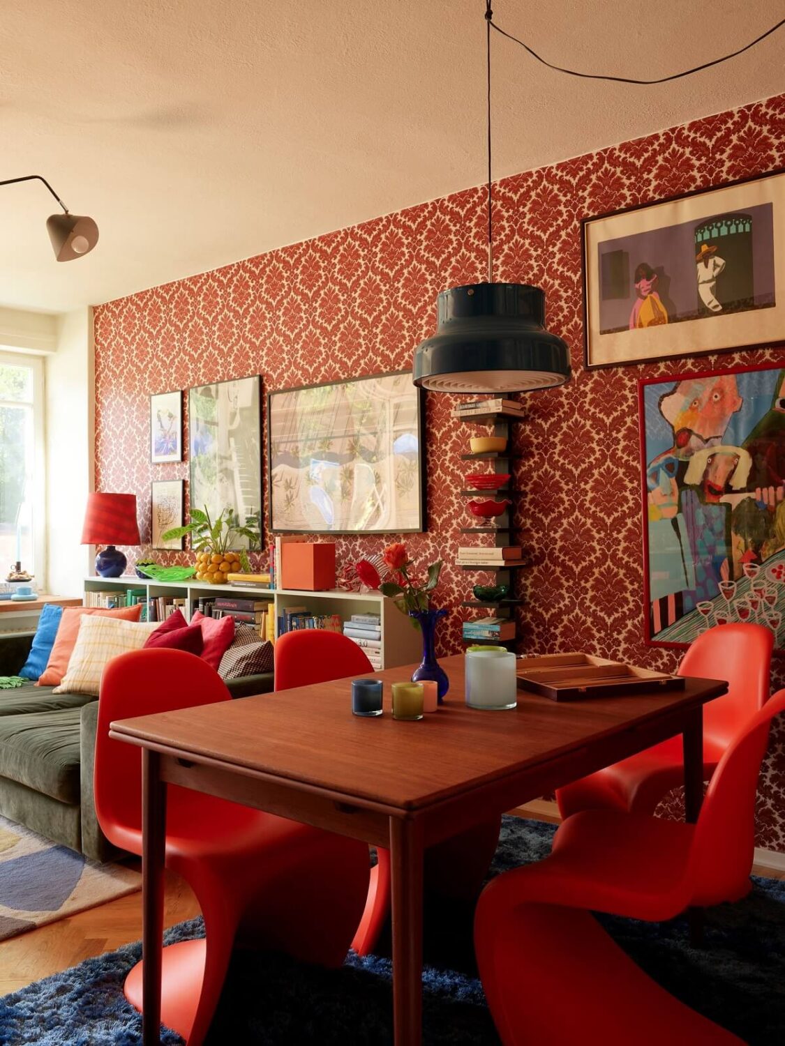 A Colorful Swedish Apartment Inspired by the 50s and 70s 15 colorful living room with red dining chairs and wallpaper nordroom