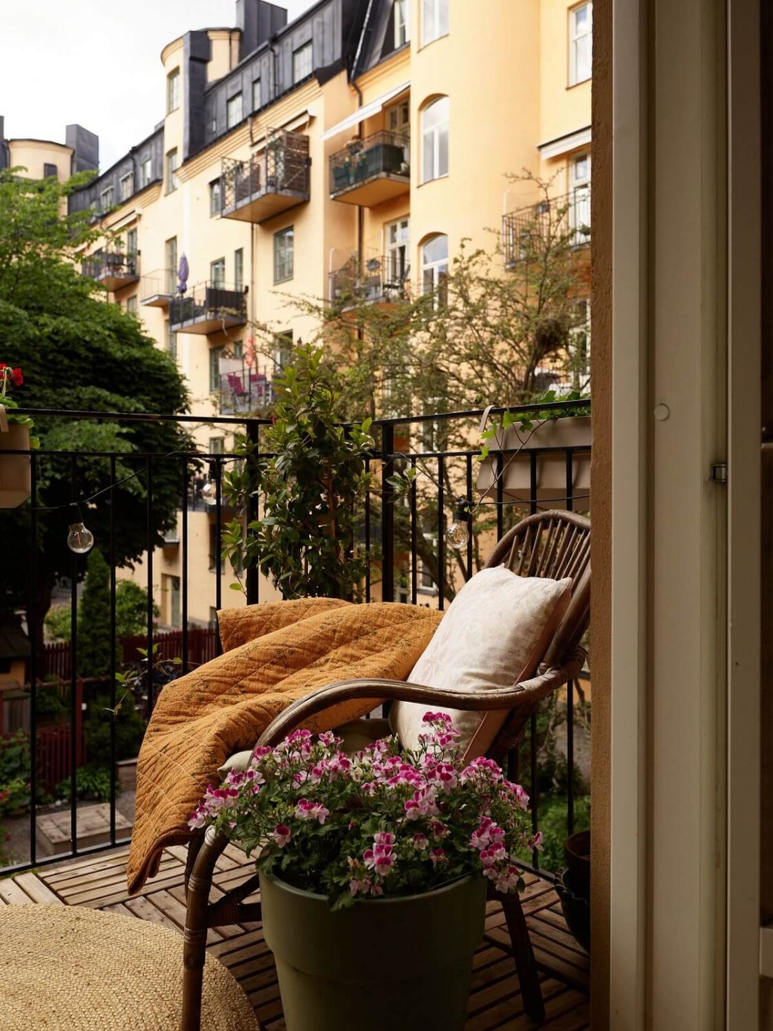 A Cozy 1920s Apartment with Original Details and Wallpaper 23 courtayd balcony chair