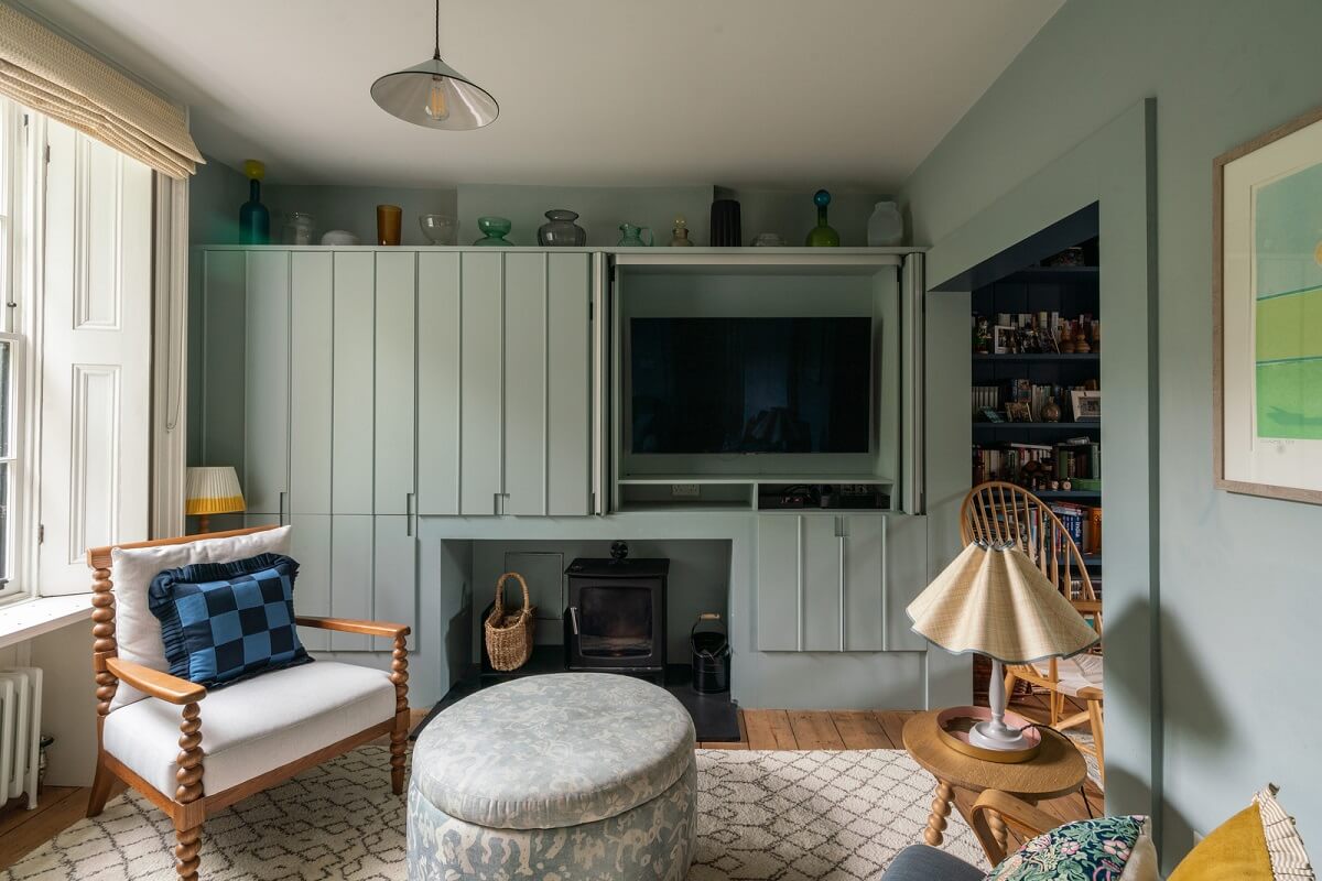 A Beautiful London Family Home with Colorful Accents 3 custom storage system hides television nordroom
