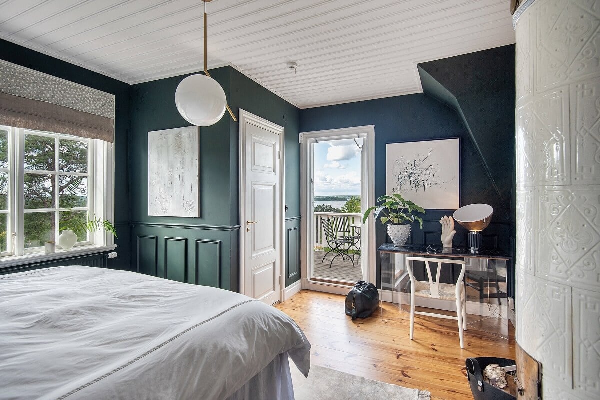 A Yellow Swedish Villa with Views of the Sea 12 dark blue bedroom with balcony