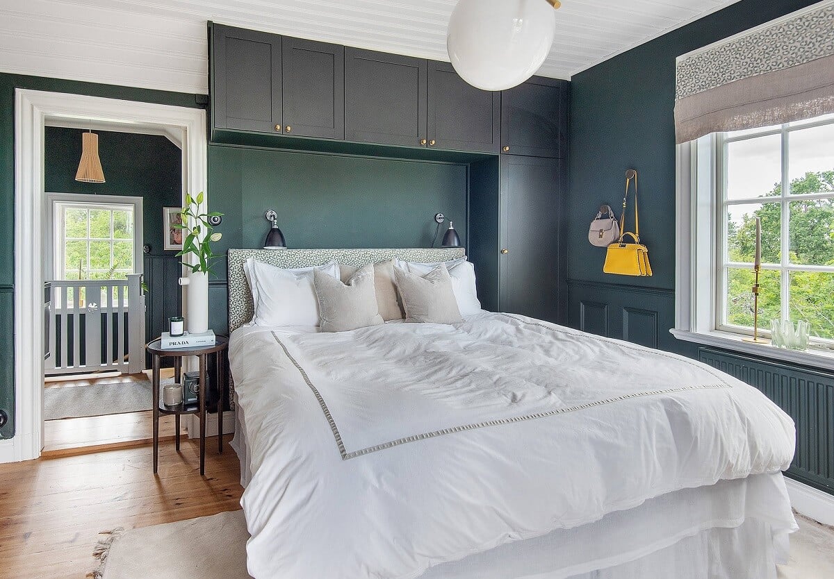 A Yellow Swedish Villa with Views of the Sea 15 dark blue bedroom with closets above bed