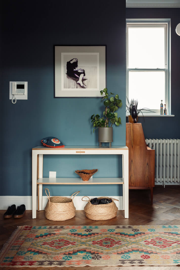 A London Duplex Apartment with a Purple Kitchen 6 dark blue hallway with colorful rug