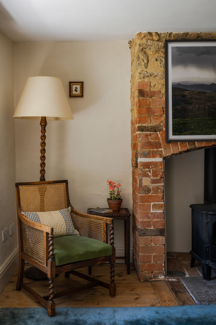 A Charming English Cottage with Historic Details 6 dining room antique chair brick fireplace