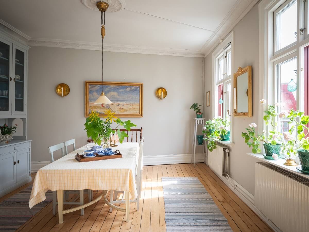 Charming Vintage Country Style in a Family Apartment in Sweden 6 dining room with gray walls and wooden floor