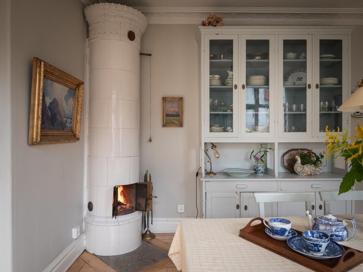 Charming Vintage Country Style in a Family Apartment in Sweden 8 dining room with tiled fireplace