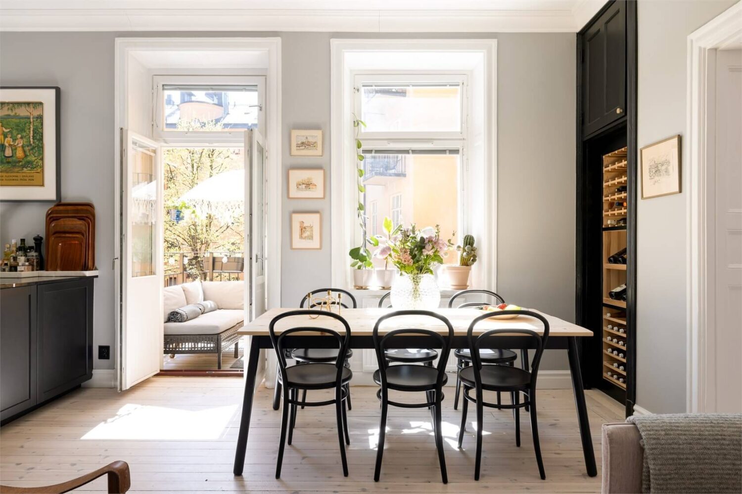 A Lovely Stockholm Apartment with a Black Kitchen and Pink Bedroom 14 dining table in open plan living space