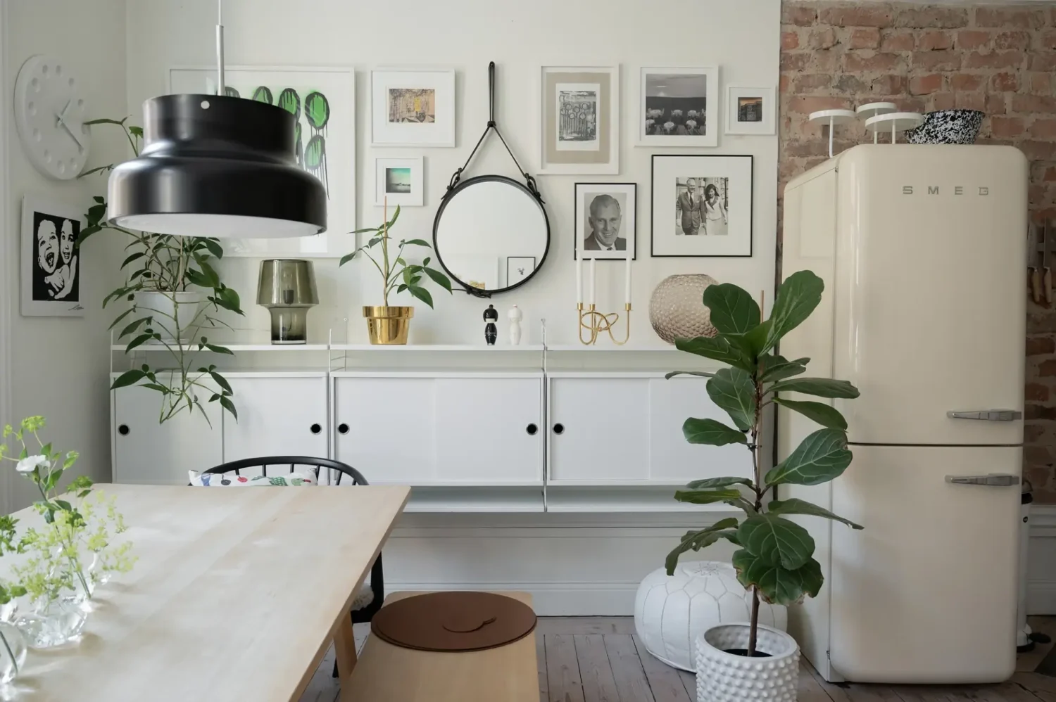 A Small Bright Scandinavian Studio Apartment 7 floating white cabinets and gallery wall